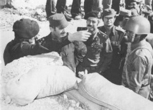 Hafez al-Assad (second from left) is briefed by one of his officers in a reserve trench. Next to Hafez al-Assad is Defense Minister Mustafa Tlas, and next to Tlas is Rifaat al-Assad, 1973.